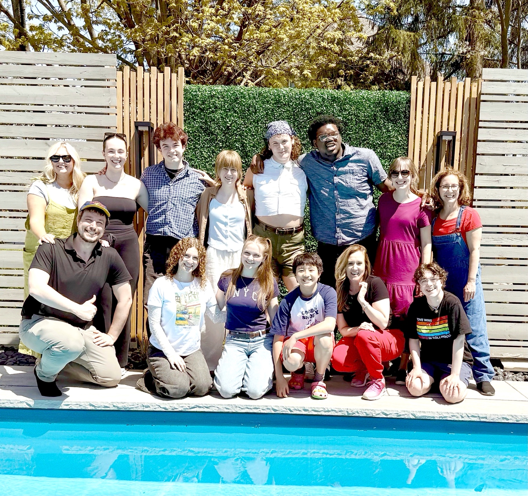 The Mair Young Company posing together outdoors on a sunny day.